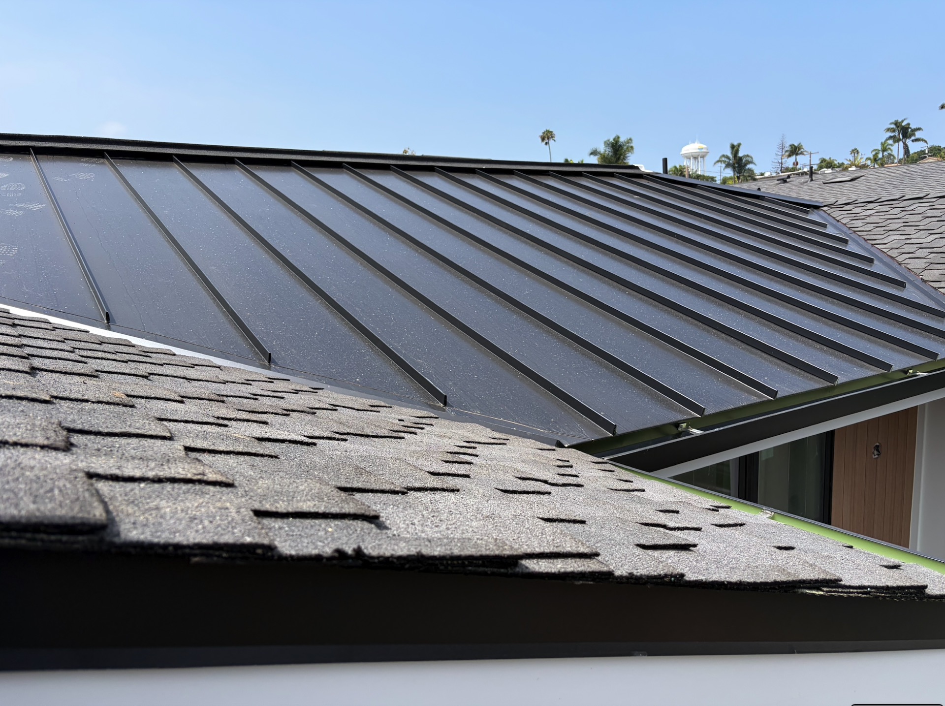 Custom black standing-seam metal roof installation