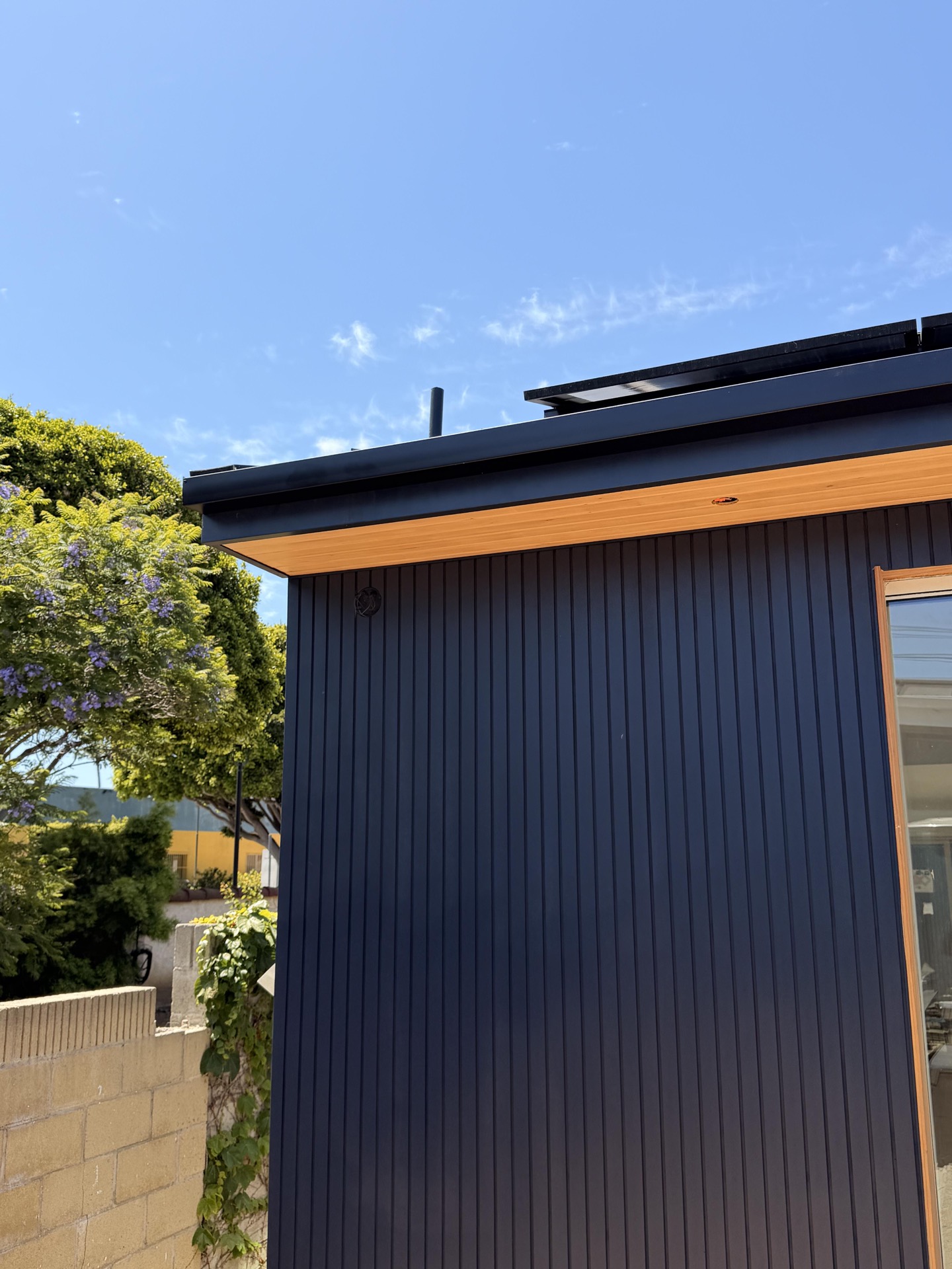 Black metal gutter installation on a modern home